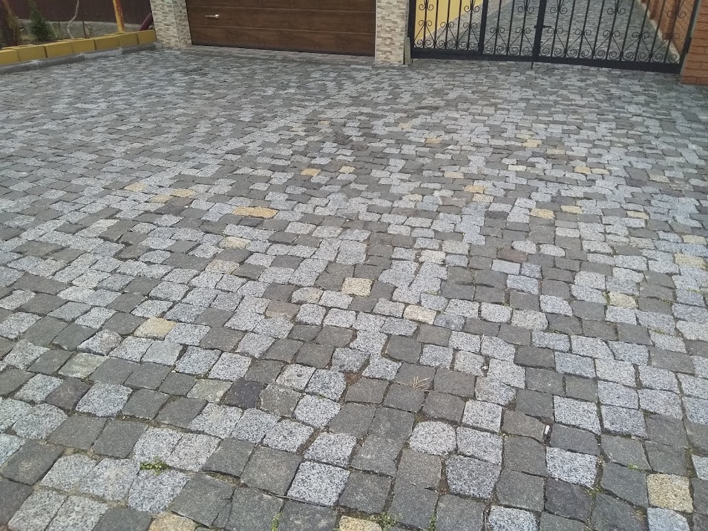 Paving of paving stones from black stone Gabbro and grey granite