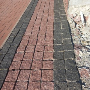 Paving stones made of black stone Gabbro and red granite
