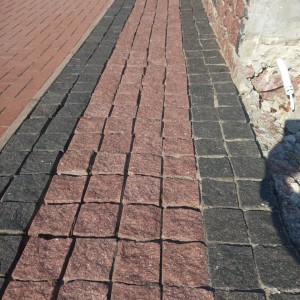 Paving stones made of black stone Gabbro and red granite