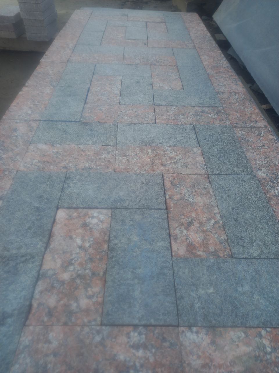 Red granite and black labradorite paving stones