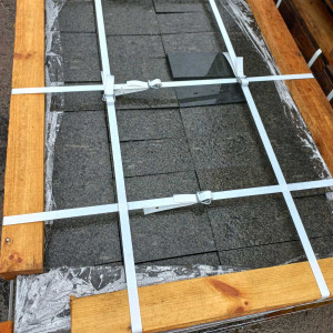 Sawn paving stones from black Gabbro stone on a pallet