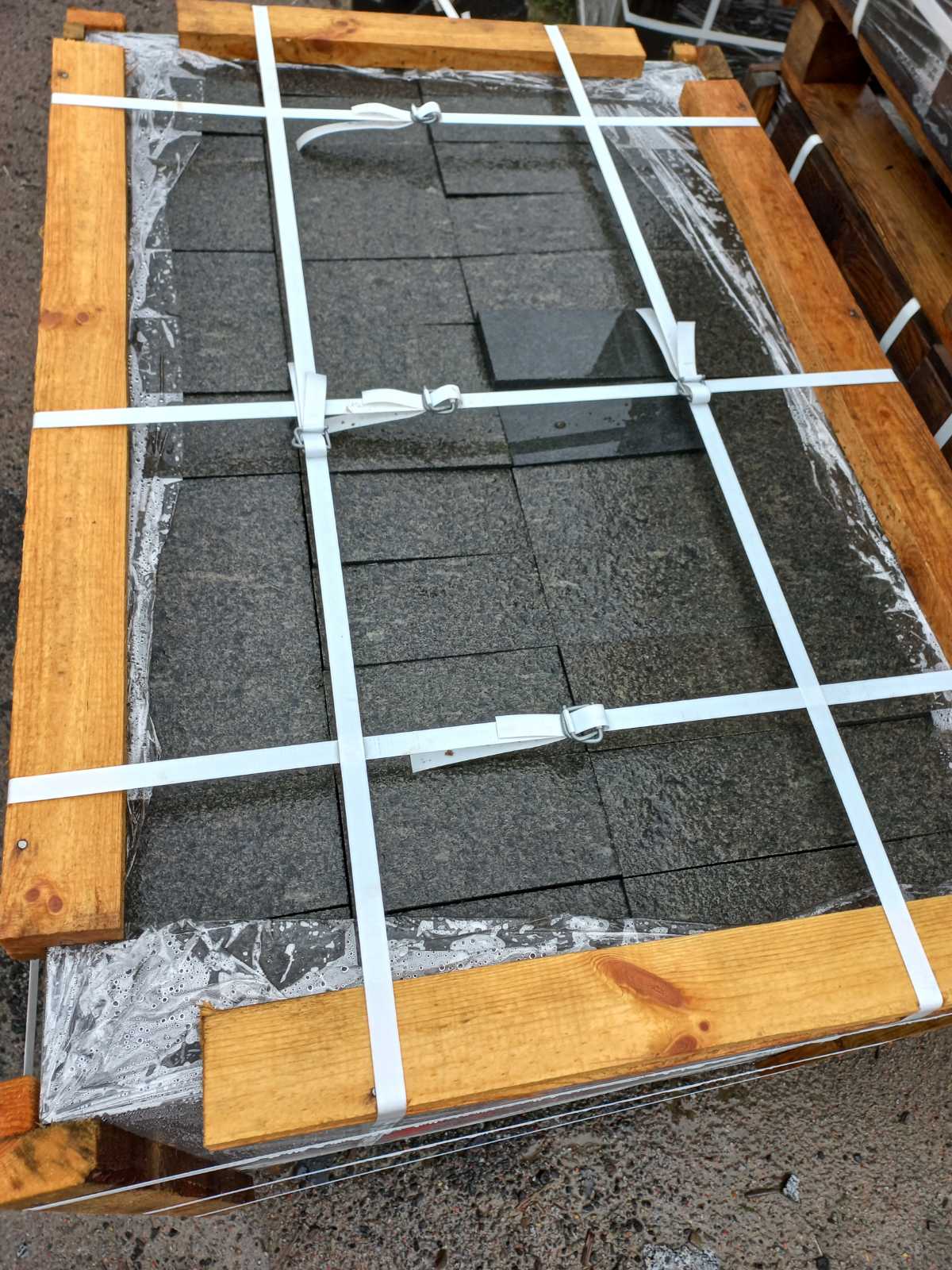 Sawn paving stones from black Gabbro stone on a pallet