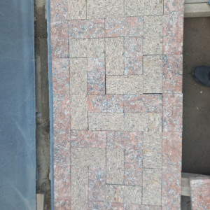 Laying of sawn paving stone from two types of granite