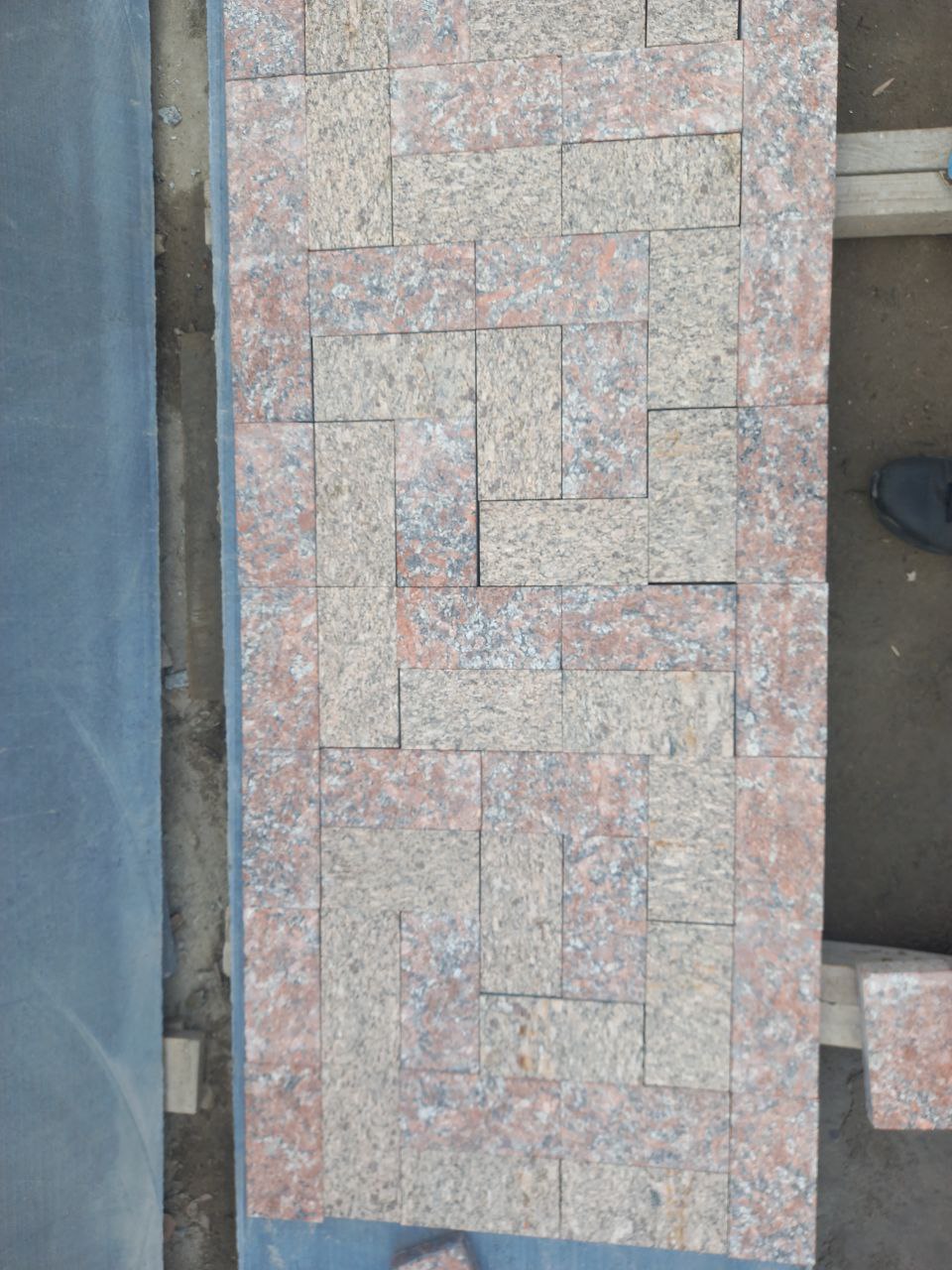 Laying of sawn paving stone from two types of granite