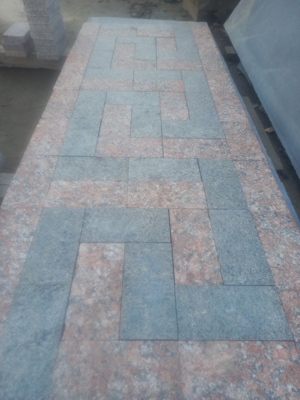Sawn paving stone made of red granite Rosso Santiago and labradorite Irina Blue