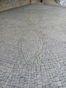 Paving with tumbled paving stones made of black Gabbro stone