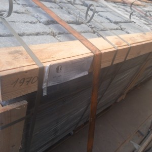 Packing of tumbled paving stones made of gabbro stone