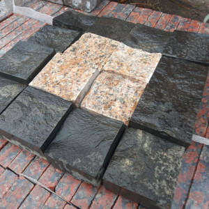 Paving stone from pink granite and black stone Basalt