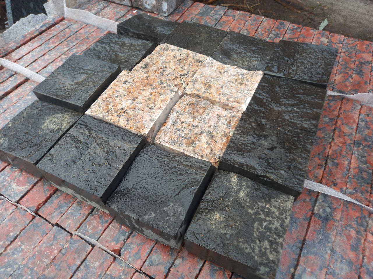 Paving stone from pink granite and black stone Basalt