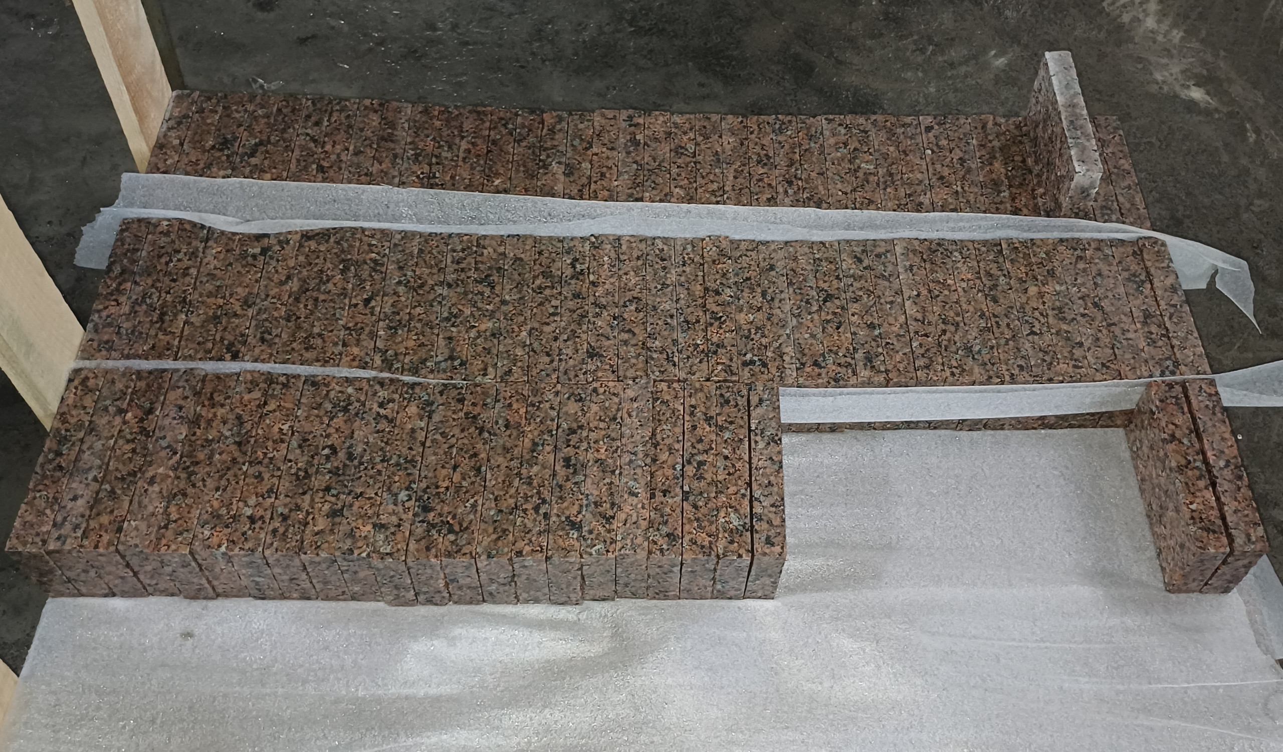 Sawed granite paving stone stacked on a pallet