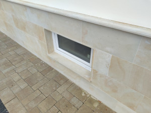 The base of the house is clad with sandstone