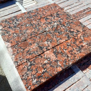 Wet red granite paving stones, flamed top