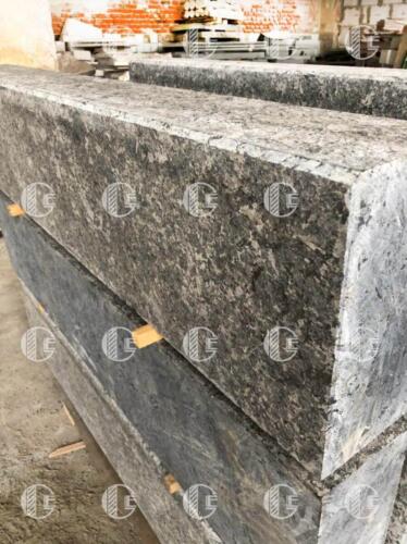 Curb made of gray granite interspersed with natural minerals