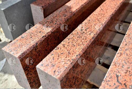 Polished red granite curb with lots of black and brown flecks
